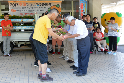 写真：太陽の家入所者から花の苗を受け取る国体協力会の代表