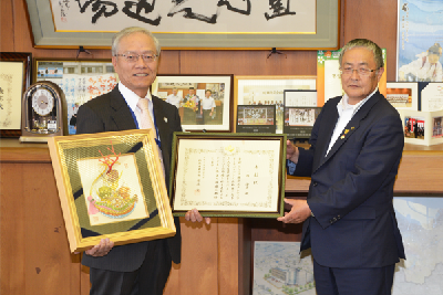 写真：表彰状と記念品を持った一柳氏と市長