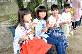 写真：フランクフルトを食べる子どもたち
